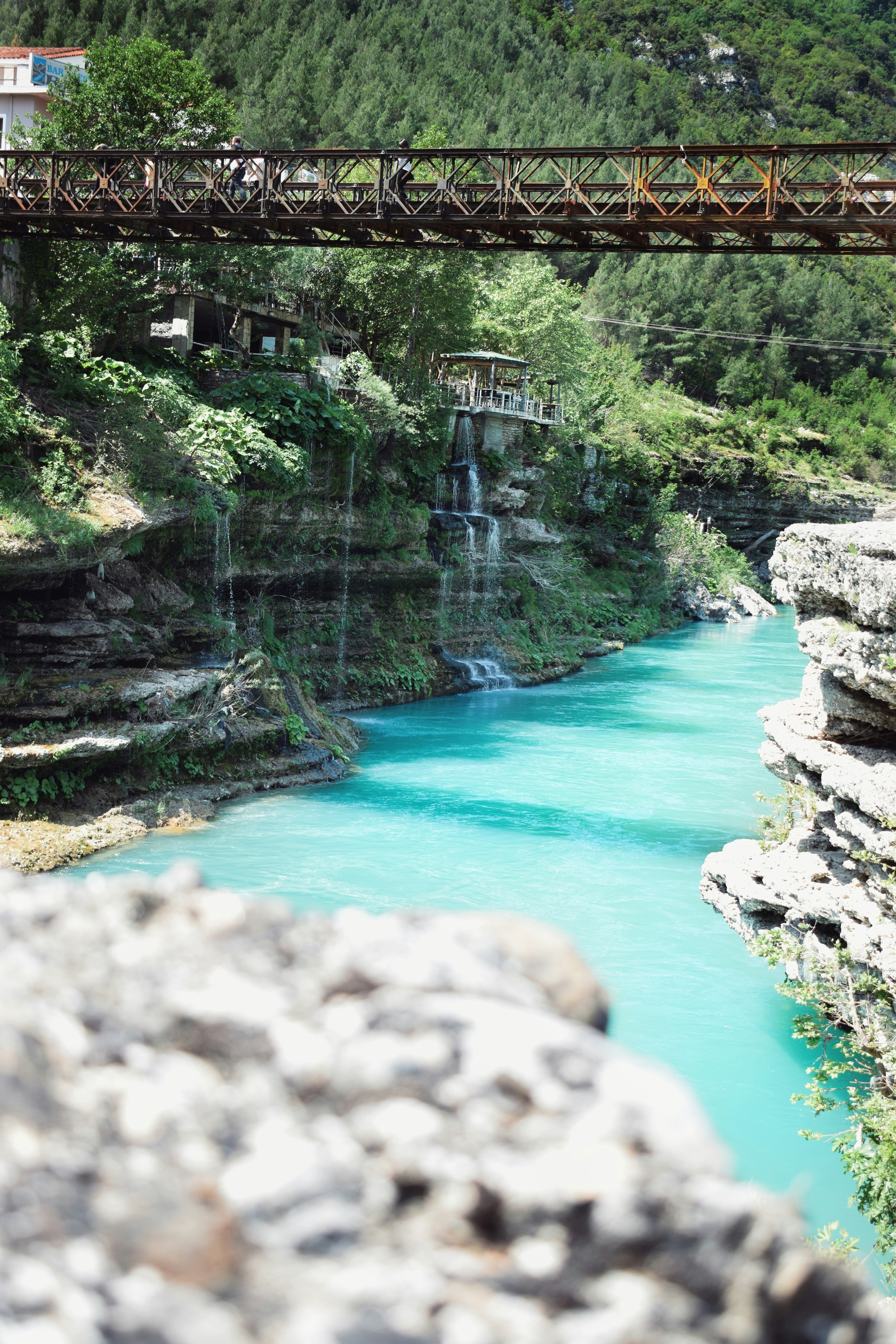 An 18th-century Ottoman bridge spanning the turquoise waters of the Benja Thermal Baths in Përmet.